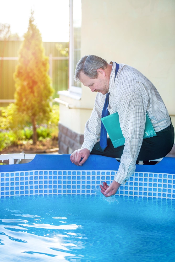 A Man In A Tie And Shirt Kneels In A Pool
